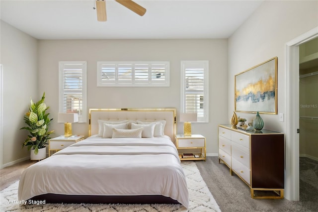 carpeted bedroom featuring ceiling fan and baseboards