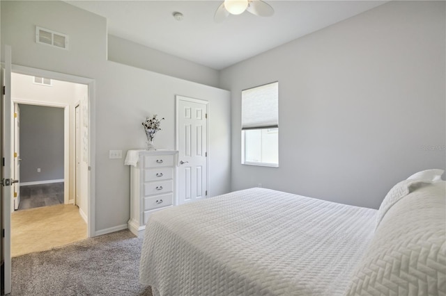 carpeted bedroom with a ceiling fan, a closet, visible vents, and baseboards