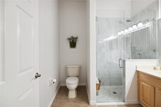 full bathroom featuring baseboards, toilet, tile patterned floors, vanity, and a shower stall