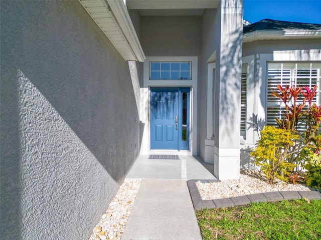 property entrance with stucco siding