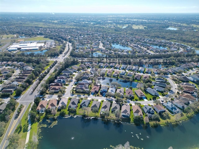 drone / aerial view with a water view and a residential view