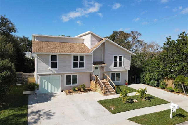 view of front of property with driveway, fence, and a front yard