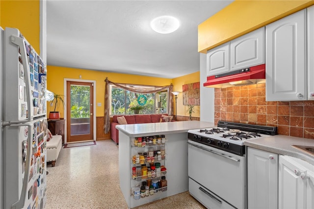 kitchen featuring white appliances, light countertops, under cabinet range hood, white cabinetry, and light speckled floor