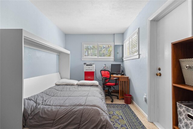 bedroom with electric panel, baseboards, and a textured ceiling