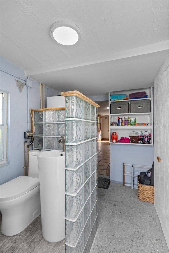 full bathroom featuring walk in shower and toilet