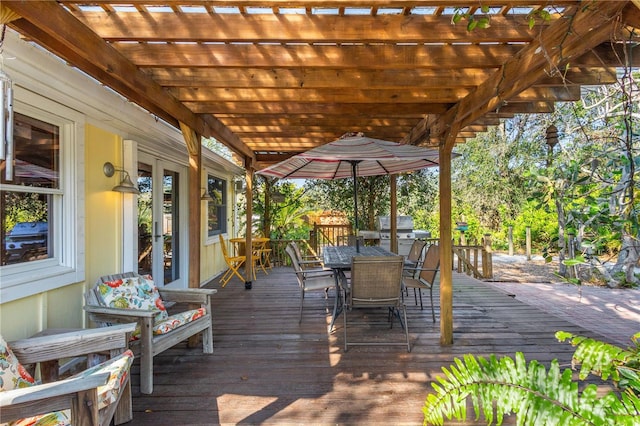 deck with outdoor dining area and a pergola