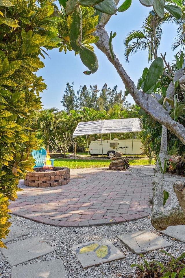 view of patio with an outdoor fire pit and a pergola