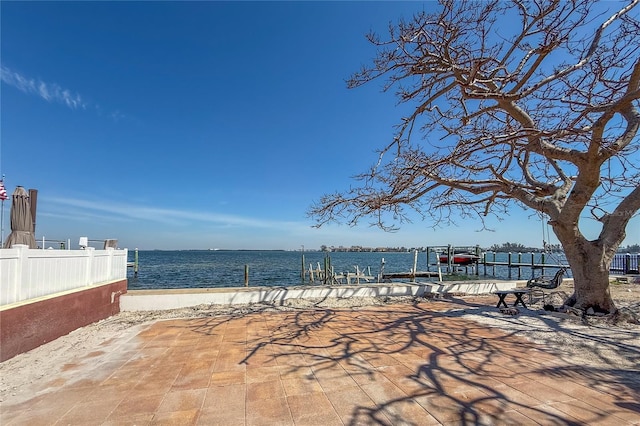 view of patio featuring a dock and a water view