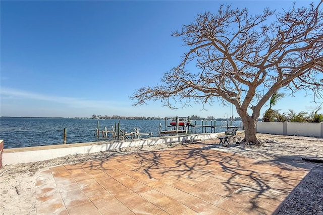 view of patio / terrace with a boat dock, a water view, and boat lift