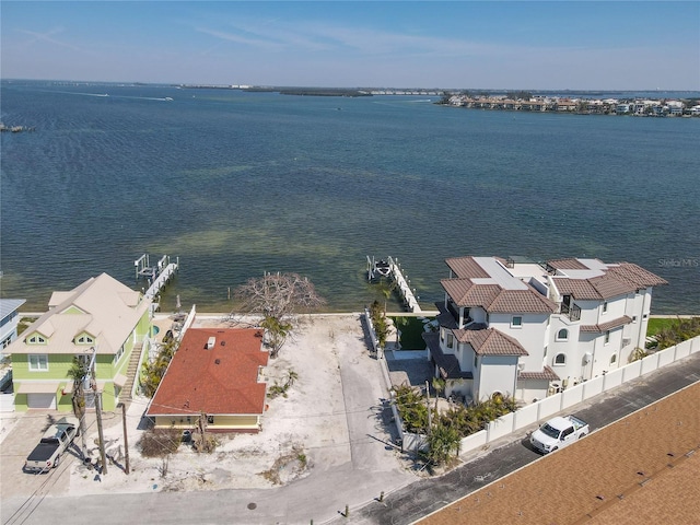 drone / aerial view with a water view and a residential view