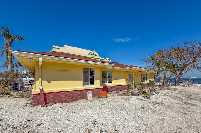 view of front of property with cooling unit and stucco siding