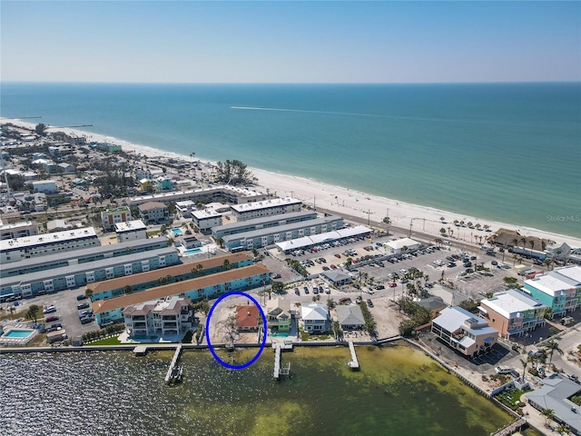 bird's eye view featuring a view of the beach and a water view