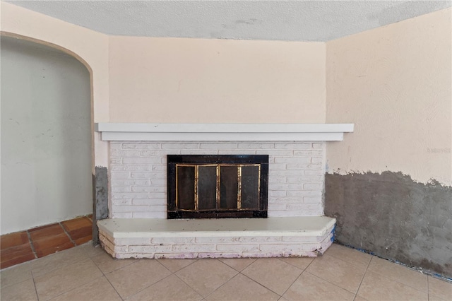 details with a brick fireplace and a textured ceiling