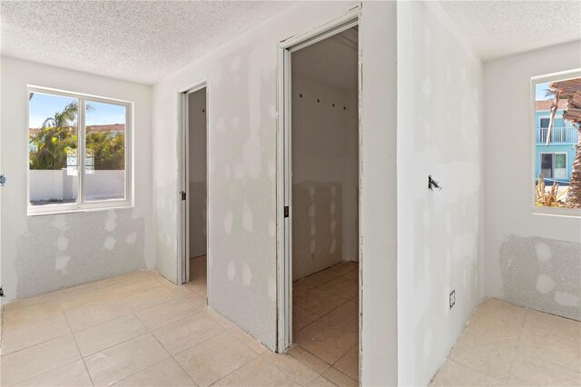 corridor featuring a textured ceiling