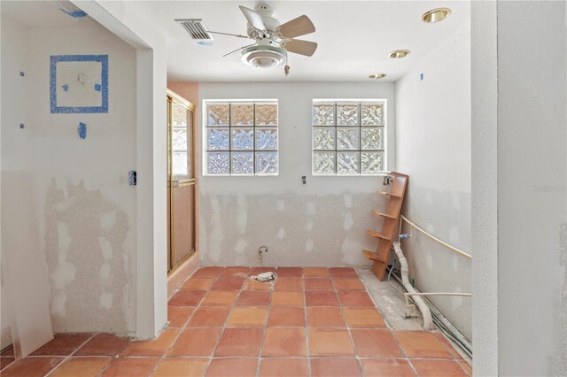 interior space featuring a ceiling fan, tile patterned flooring, and visible vents