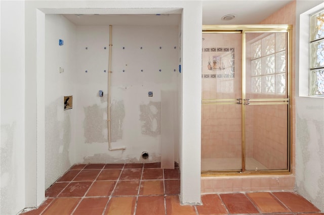 interior space with a stall shower and tile patterned flooring