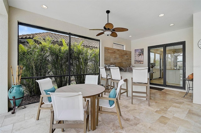 dining space featuring stone tile floors, plenty of natural light, recessed lighting, and ceiling fan