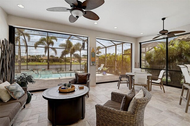 sunroom / solarium featuring a ceiling fan