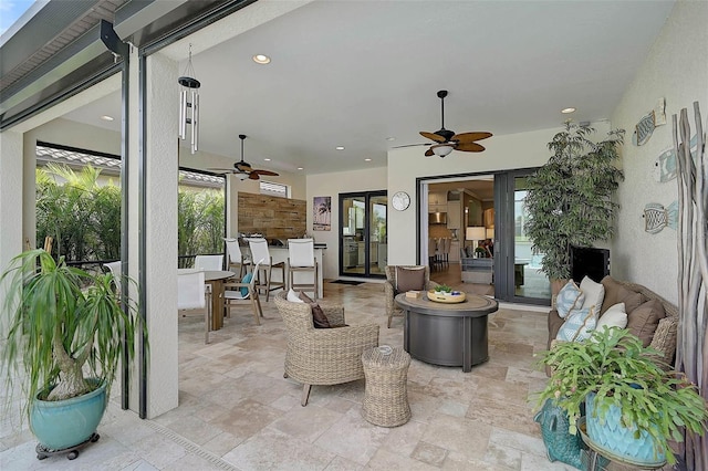 view of patio with outdoor dining space and ceiling fan