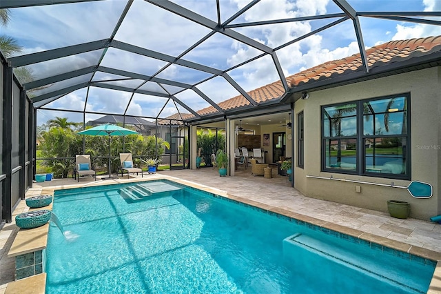 outdoor pool featuring glass enclosure, a patio, and ceiling fan