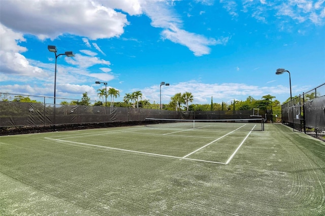 view of tennis court with fence