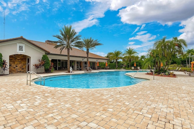 community pool with a patio area