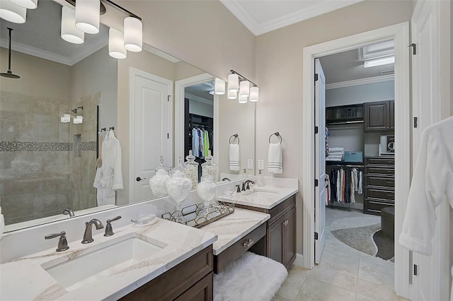 full bathroom with vanity, crown molding, a spacious closet, and a tile shower