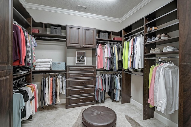 spacious closet with light tile patterned floors and visible vents