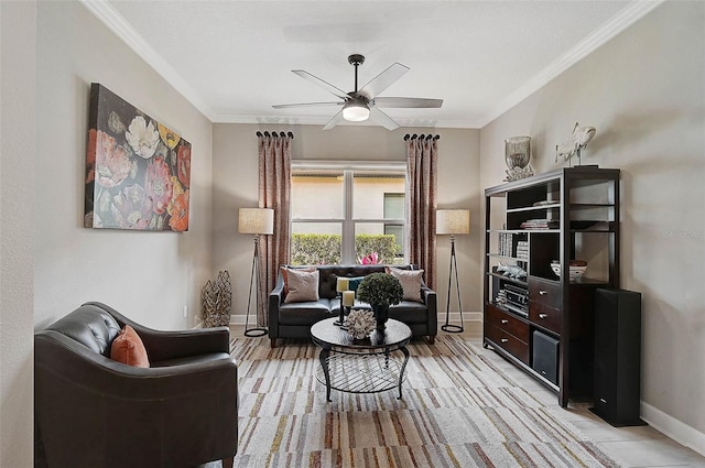 living area featuring a ceiling fan, crown molding, and baseboards