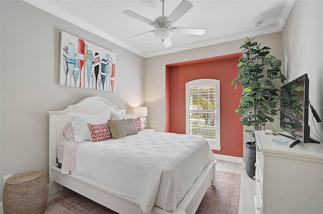 bedroom with light wood finished floors, baseboards, crown molding, and a ceiling fan