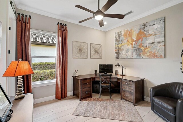 office area with visible vents, baseboards, a ceiling fan, and crown molding