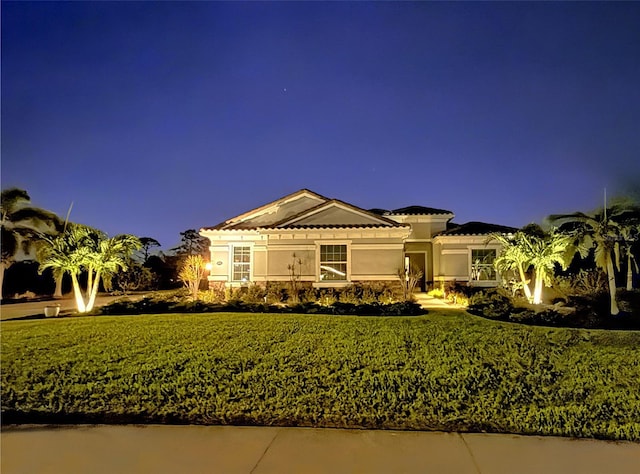 view of front of home featuring a front lawn and stucco siding