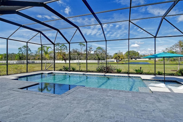 pool with a lanai, a patio area, and a yard