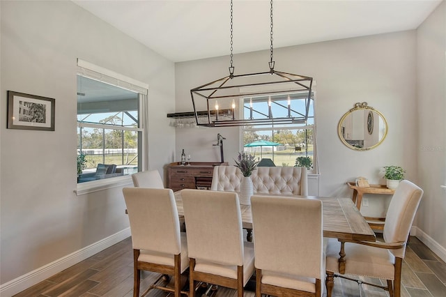 dining room with wood tiled floor and baseboards