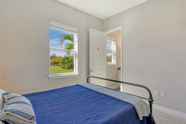 carpeted bedroom with baseboards