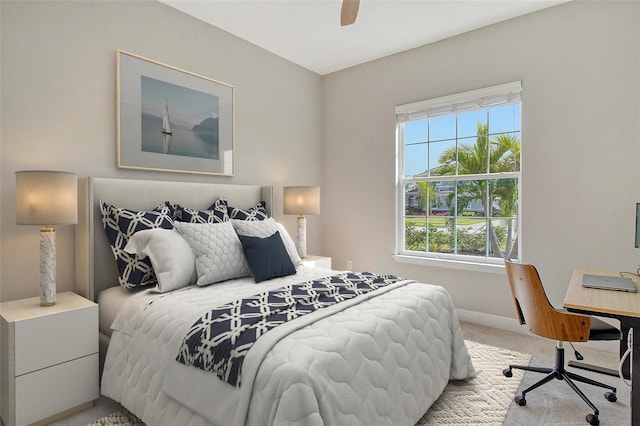 carpeted bedroom featuring baseboards and a ceiling fan