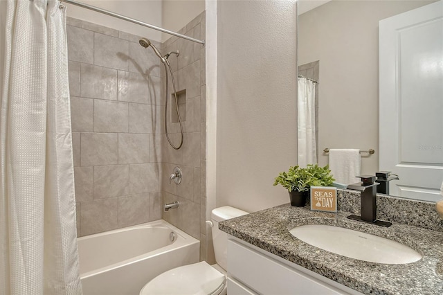 bathroom featuring toilet, shower / bath combo, and vanity