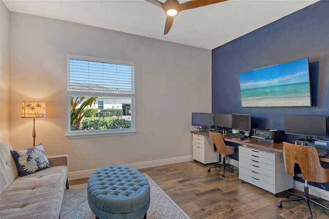 office with dark wood-type flooring, baseboards, and a ceiling fan