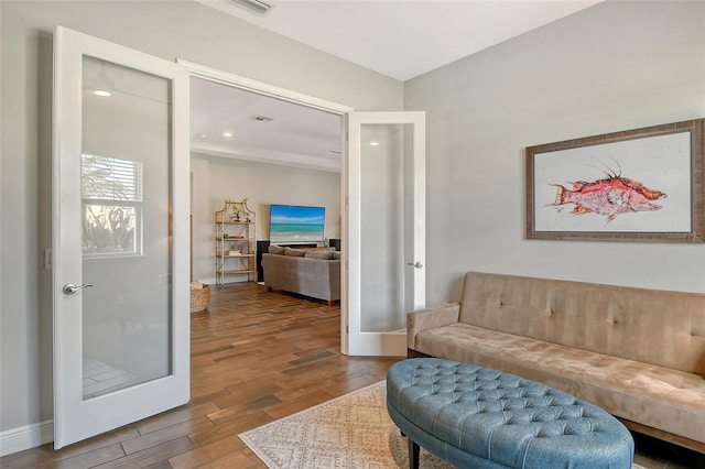 living area with recessed lighting, french doors, baseboards, and wood finished floors