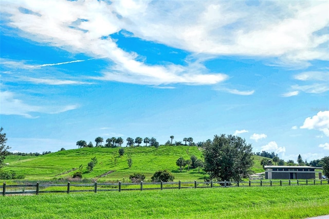 view of yard featuring a rural view and fence