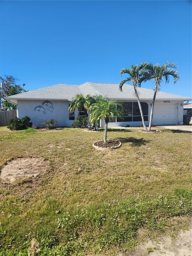 ranch-style house with stucco siding, an attached garage, a front yard, fence, and driveway