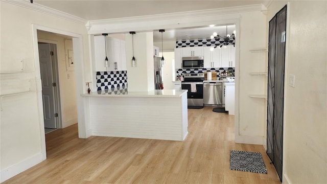 kitchen featuring tasteful backsplash, white cabinets, stainless steel appliances, crown molding, and light wood-style floors