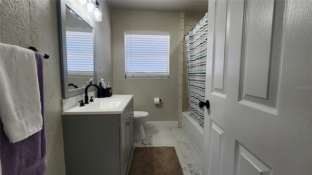 bathroom featuring toilet, shower / tub combo, vanity, baseboards, and marble finish floor