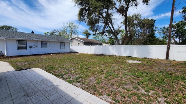 view of yard with a patio area and a fenced backyard