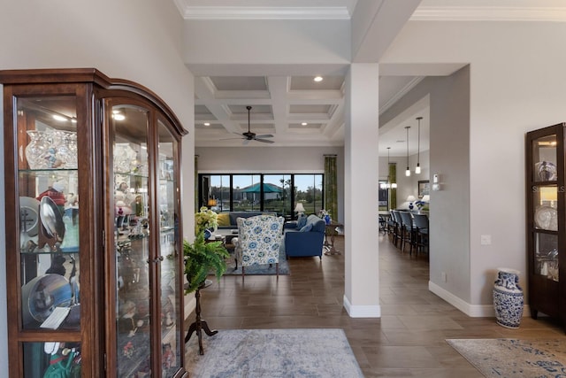 foyer with coffered ceiling, a ceiling fan, baseboards, ornamental molding, and beamed ceiling