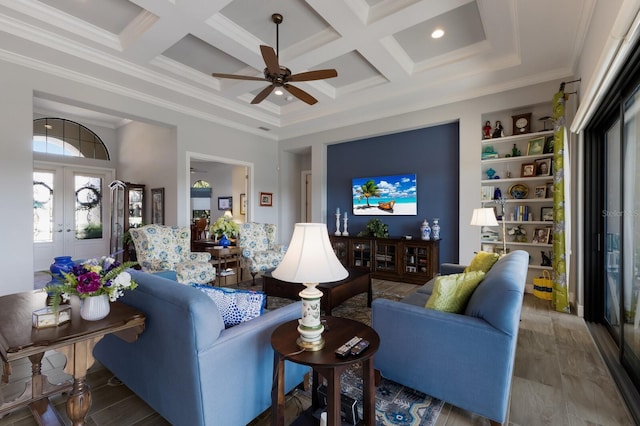 living area featuring a towering ceiling, coffered ceiling, crown molding, and french doors