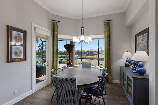 dining room with crown molding, baseboards, and an inviting chandelier