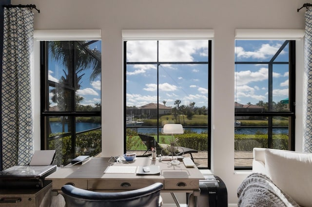 office area featuring a water view and a healthy amount of sunlight