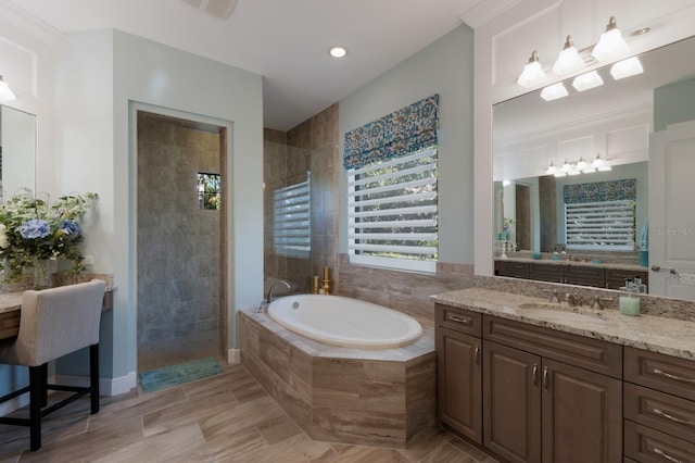 full bathroom with a walk in shower, vanity, and a bath