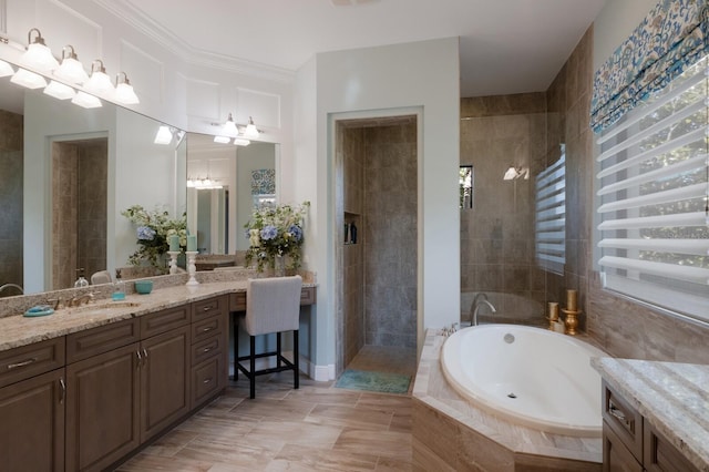 full bath featuring a garden tub, ornamental molding, a tile shower, and vanity